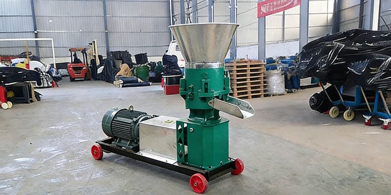 Flat die pellet mill producing uniform animal feed pellets in factory