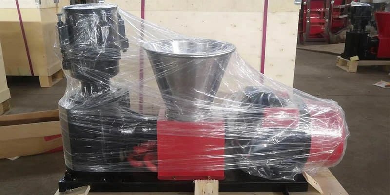 a pellet mill machine tightly wrapped in protective stretch film before crating