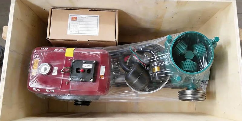 a labeled box of spare parts and manuals securely placed inside a larger shipping crate