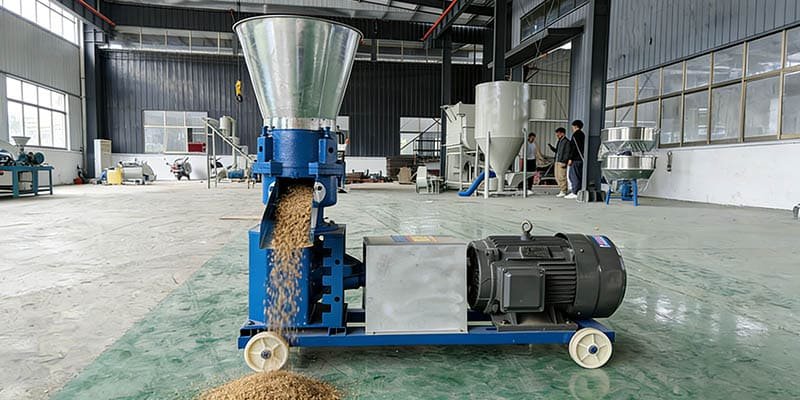 A small feed pellet machine turning grain mix into finished pellets.