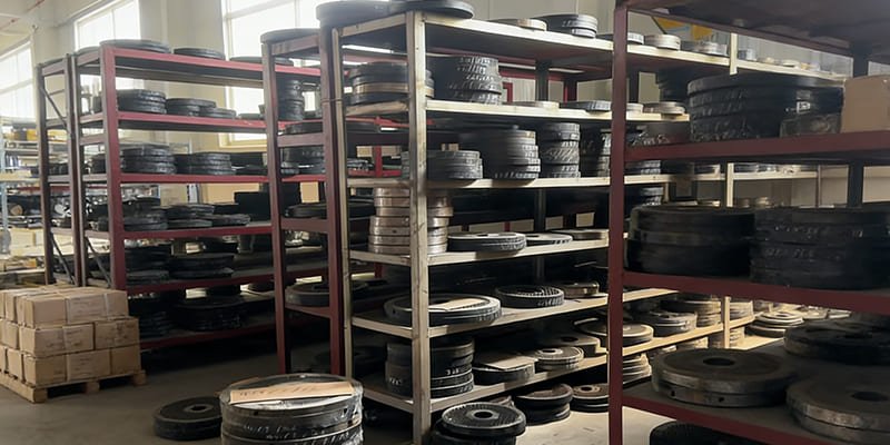 A warehouse shelf with spare parts like dies and rollers